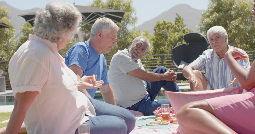 Group of Seniors Enjoying Outdoor Picnic and Conversation - Free Images, Stock Photos and Pictures on Pikwizard.com