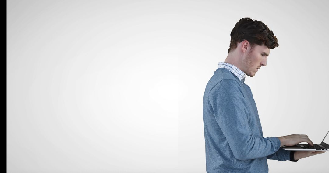 Young Professional Focused on Computer Work in Casual Attire