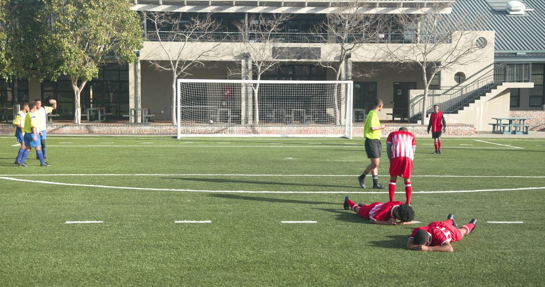 Soccer Player Injured During Match, Teammate Offering Support