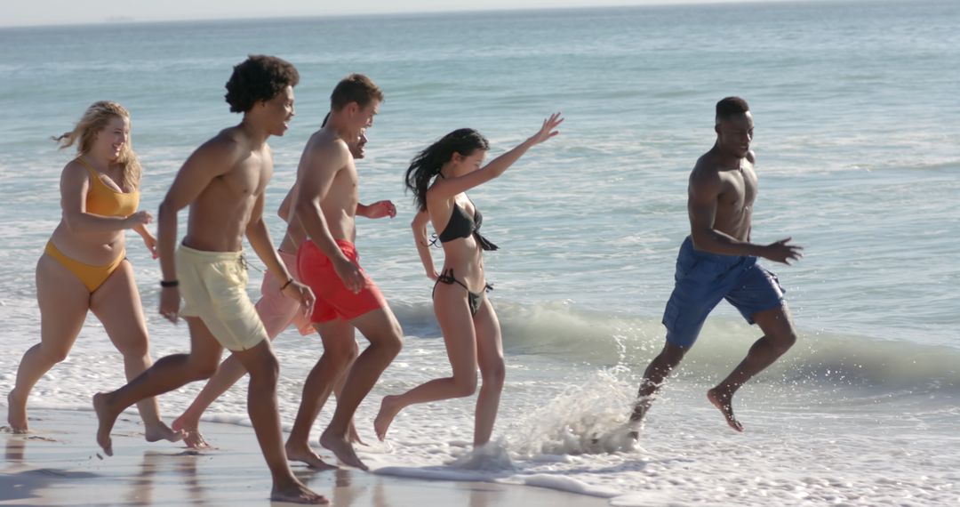 Diverse Group of Friends Enjoying Beach Fun and Waves
