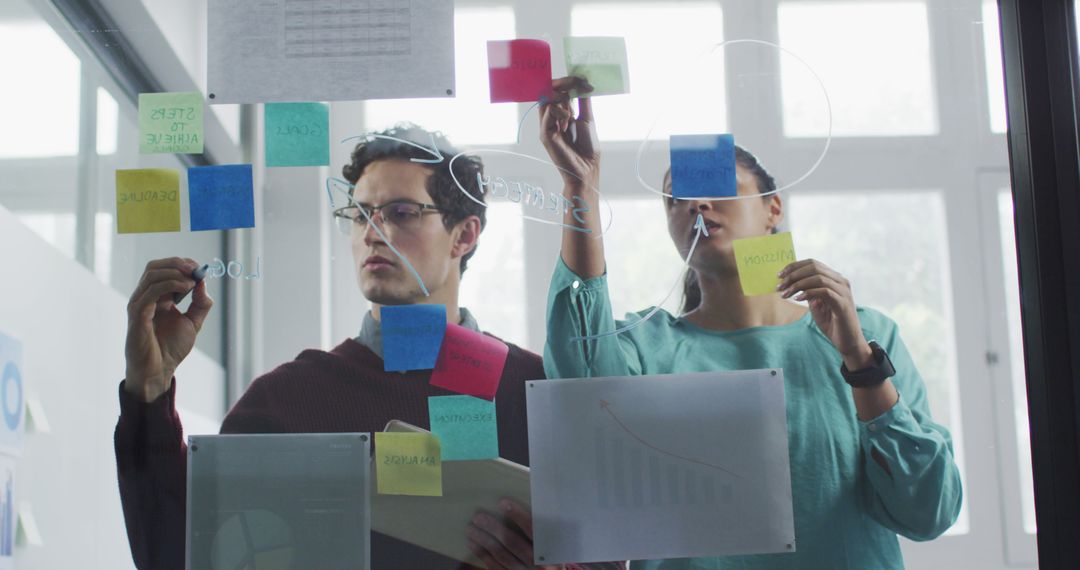 Diverse Colleagues Brainstorming with Notes in Modern Office