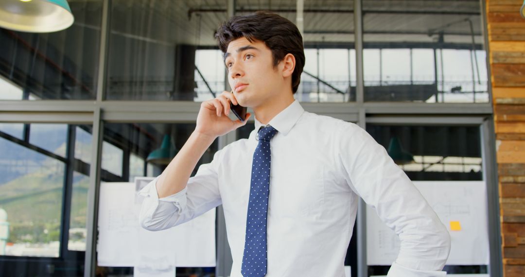 Serious Businessman Talking on Phone in Modern Office - Free Images, Stock Photos and Pictures on Pikwizard.com