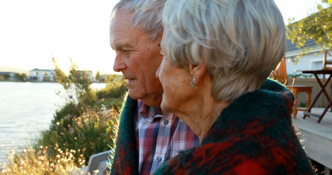 Elderly Couple Relaxing Near Lake On Beautiful Sunny Day - Free Images, Stock Photos and Pictures on Pikwizard.com