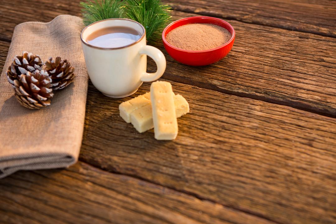 Pine cone, coffee cup, coffee powder, sweet food, and christmas fir with napkin - Free Images, Stock Photos and Pictures on Pikwizard.com