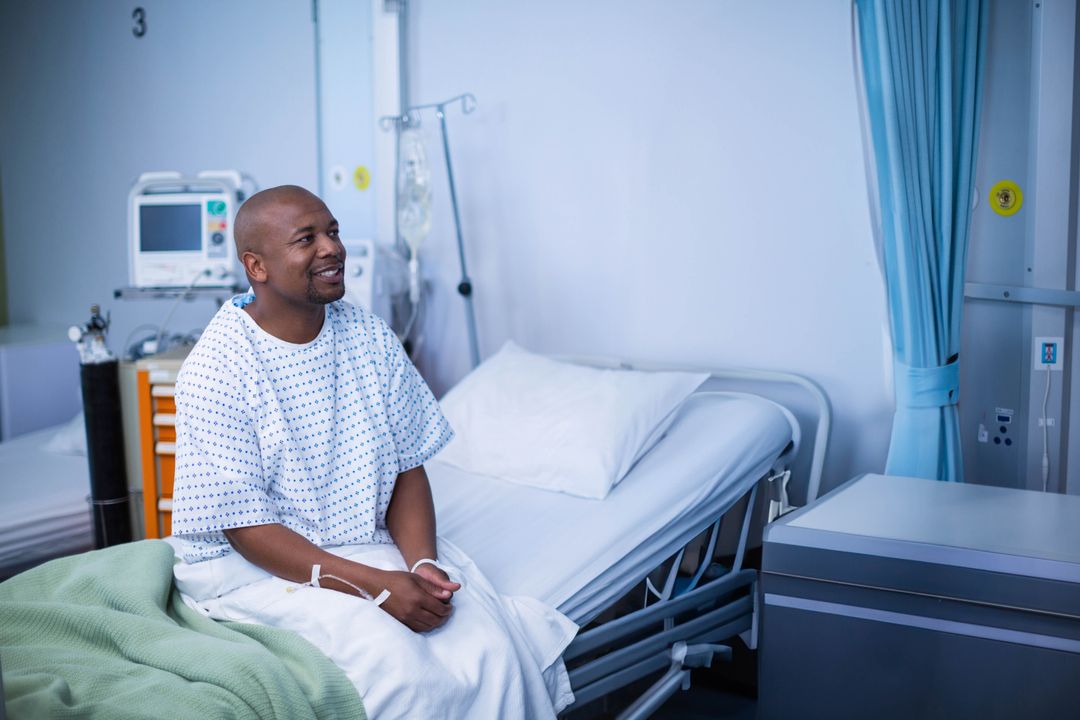 Smiling Patient Sitting on Hospital Bed in Medical Gown