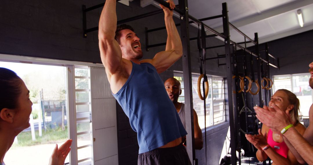 Man Doing Pull-Ups in Gym with Friends Cheering - Free Images, Stock Photos and Pictures on Pikwizard.com