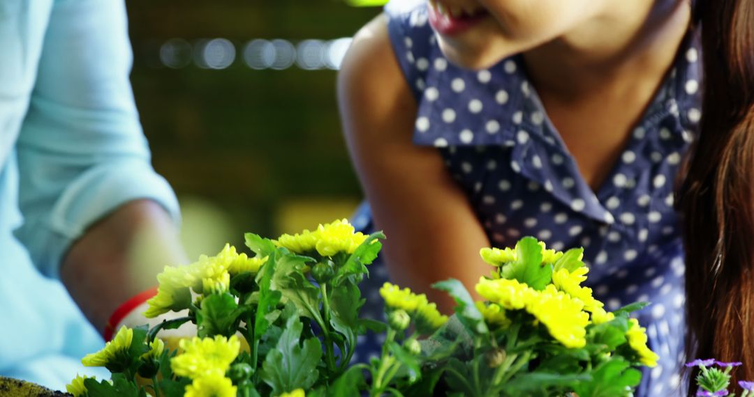 Young Girl Gardening with Yellow Flowers in Springtime - Free Images, Stock Photos and Pictures on Pikwizard.com