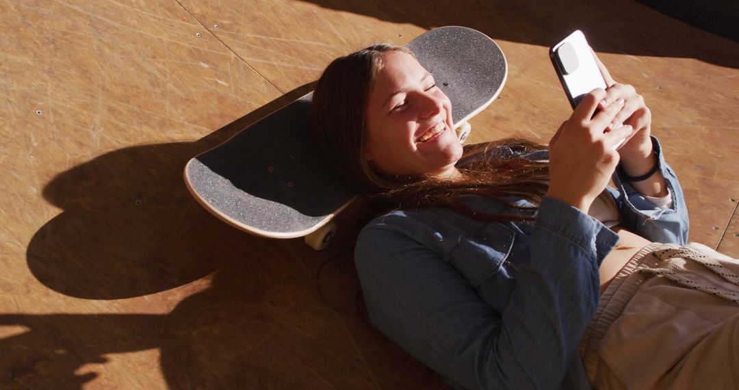 Teenager Relaxing on Skateboard Using Smartphone - Free Images, Stock Photos and Pictures on Pikwizard.com