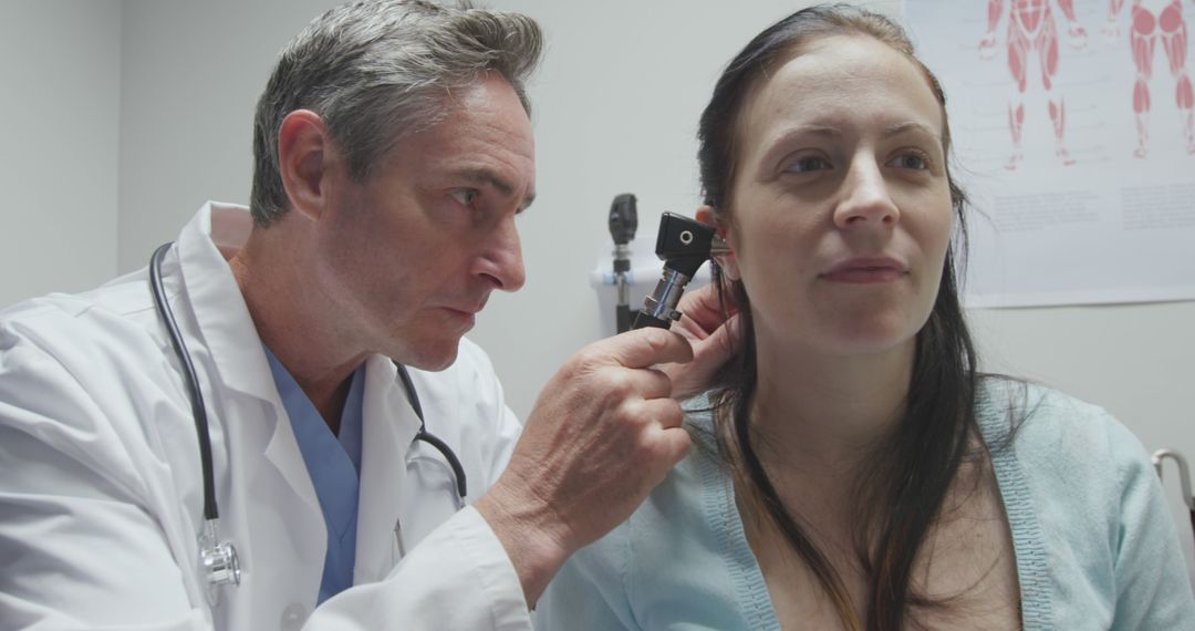 Doctor Examining Patient's Ear in Medical Office - Free Images, Stock Photos and Pictures on Pikwizard.com