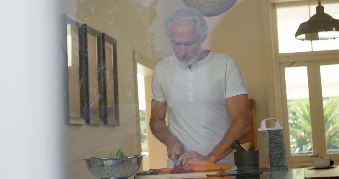 Senior man preparing healthy meal in kitchen - Free Images, Stock Photos and Pictures on Pikwizard.com