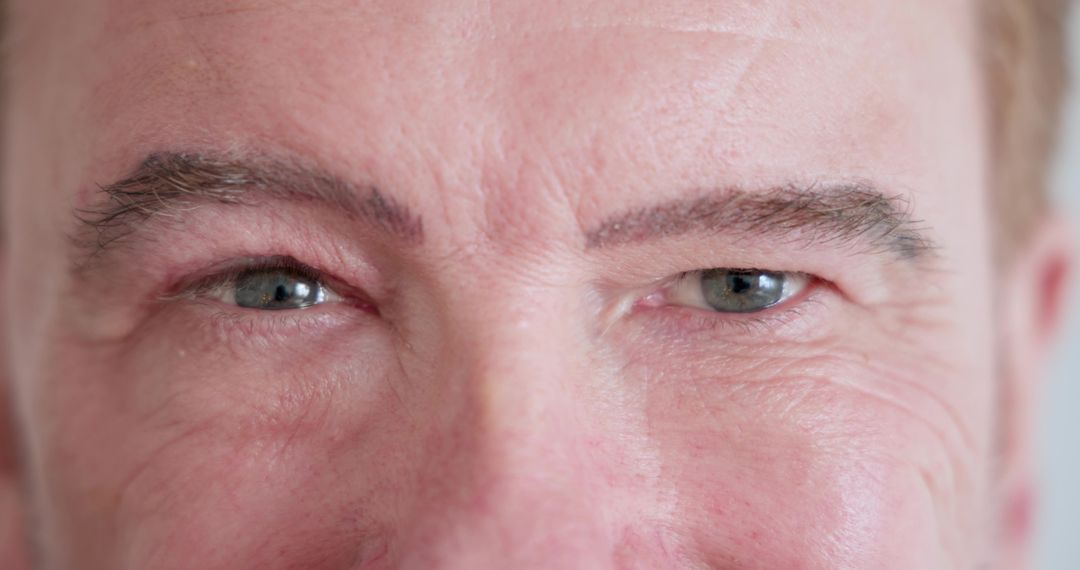 Mature Man's Over-Eye Close-Up Showing Pores and Stubble