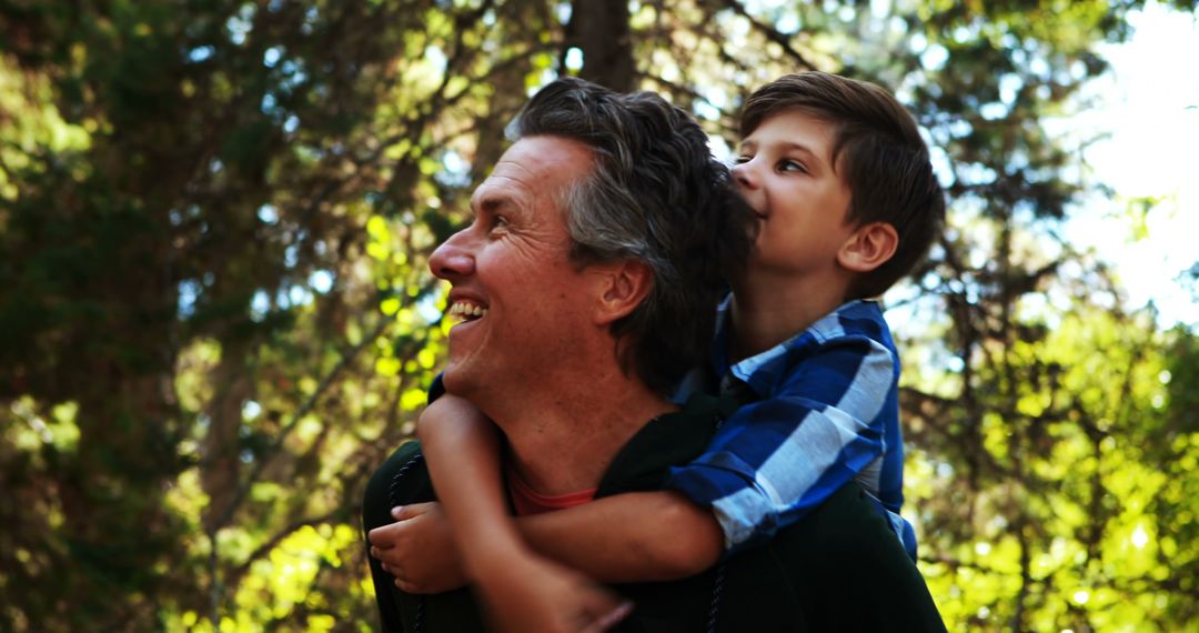 Happy Father Carrying Son on Shoulders in Forest - Free Images, Stock Photos and Pictures on Pikwizard.com