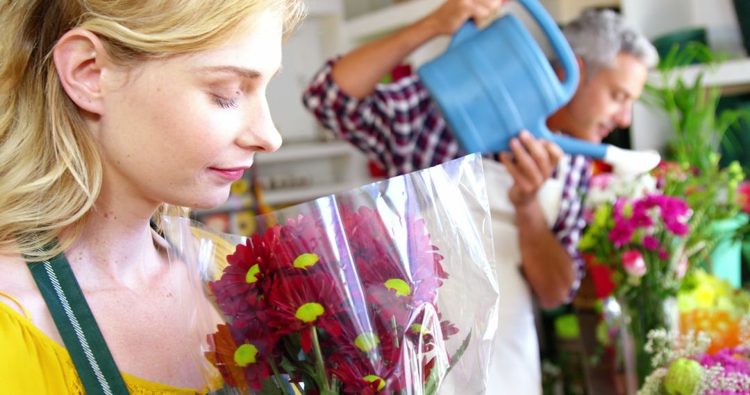 Female Florist Enjoying Floral Scent in Flower Shop - Free Images, Stock Photos and Pictures on Pikwizard.com