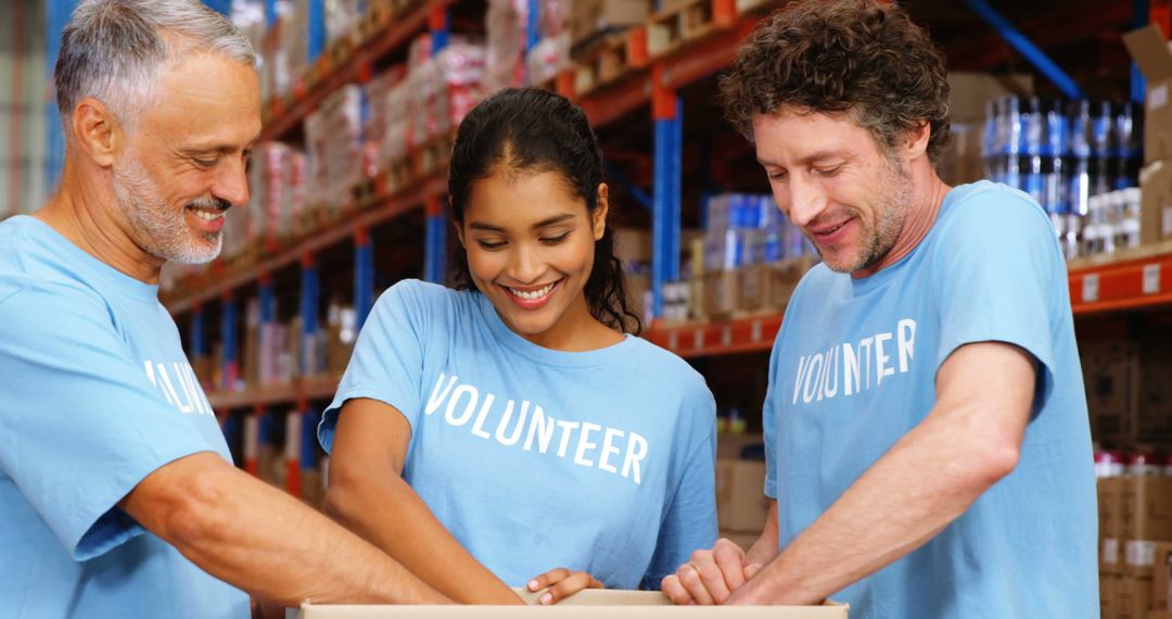 Diverse Group of Volunteers Packing Boxes in Warehouse - Free Images, Stock Photos and Pictures on Pikwizard.com