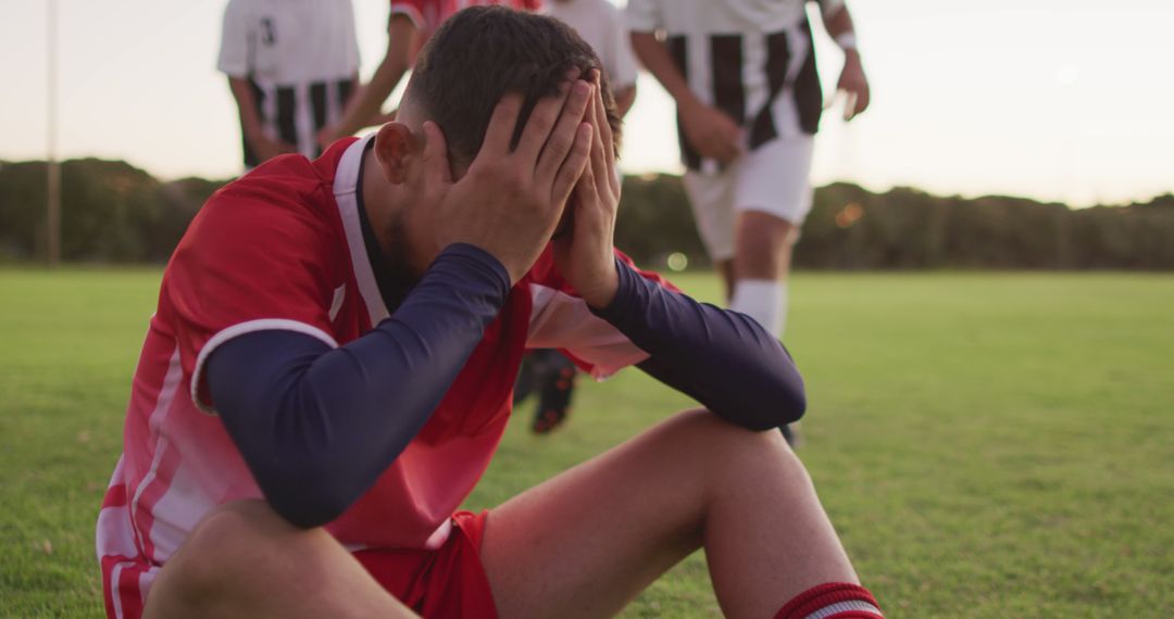 Frustrated Soccer Player Sitting on Field - Free Images, Stock Photos and Pictures on Pikwizard.com