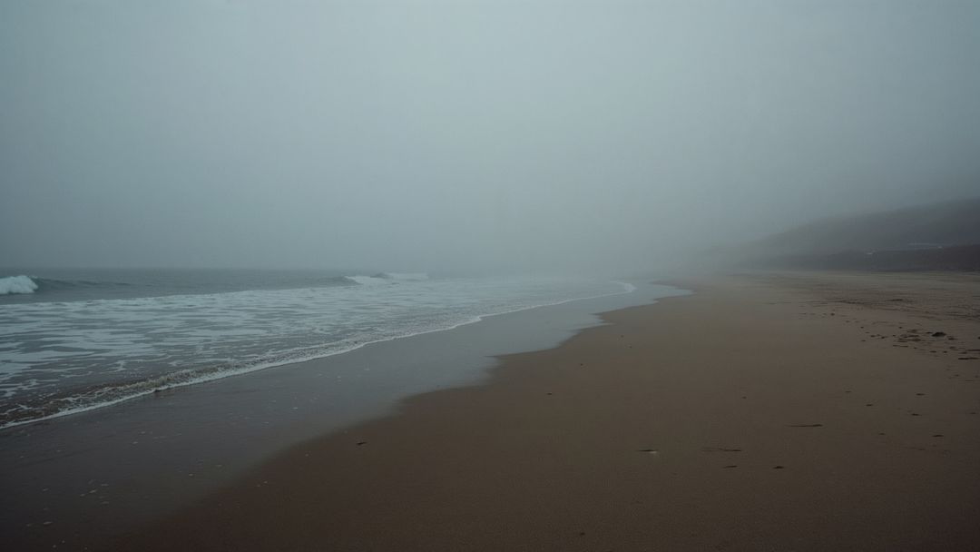Misty Coastal Landscape with Gentle Waves and Sandy Beach
