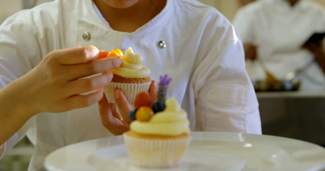 Pastry Chef Decorating Cupcakes with Fresh Fruit - Free Images, Stock Photos and Pictures on Pikwizard.com