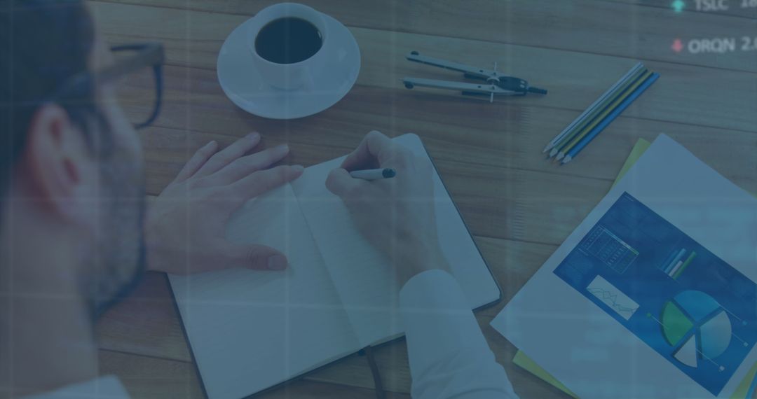 Businessman Analyzing Financial Charts at Work Desk