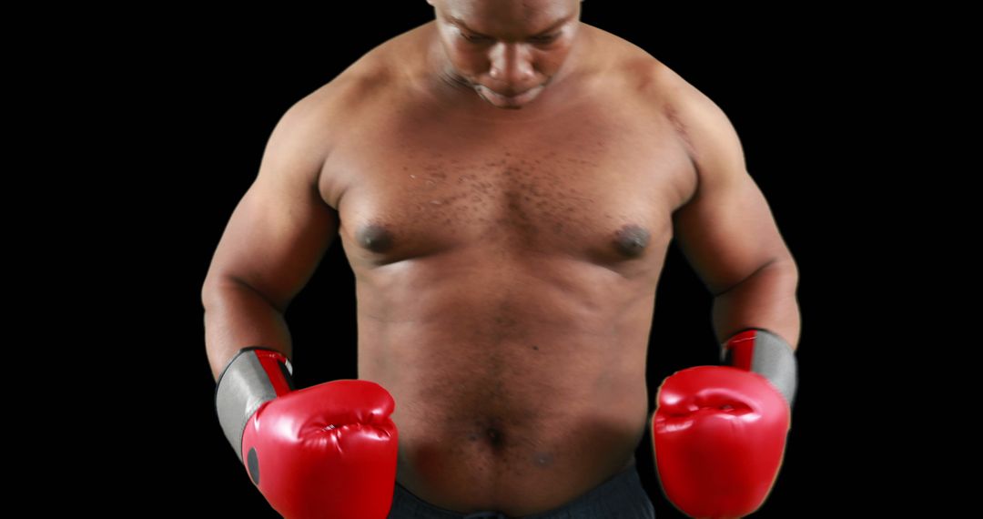 Fit African American Boxer in Red Gloves Looking Down on Black Background - Free Images, Stock Photos and Pictures on Pikwizard.com