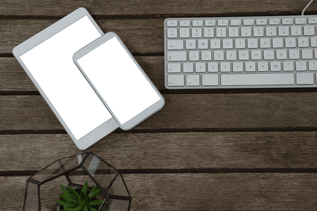 Transparent gadgets and office items rest on rustic wood surface