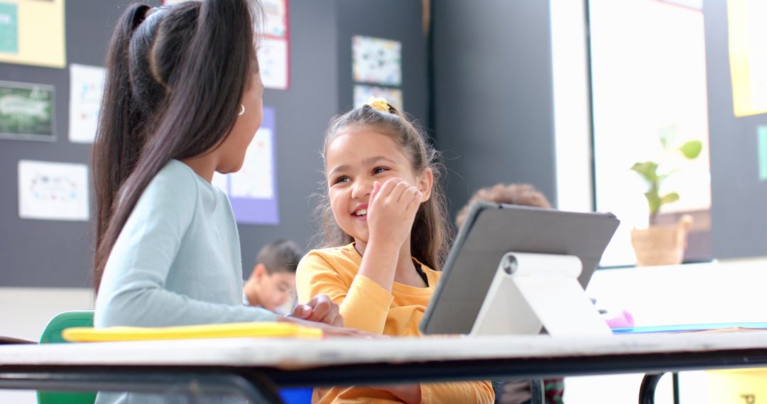 Smiling Students Engaged with Tablet Technology in Classroom