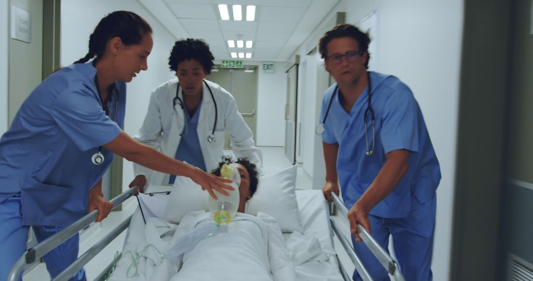 Medical Team Rushing Patient on Gurney through Hospital Hallway - Free Images, Stock Photos and Pictures on Pikwizard.com