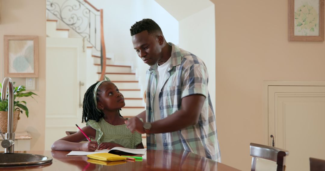 Father Helping Daughter with Homework in Bright Home