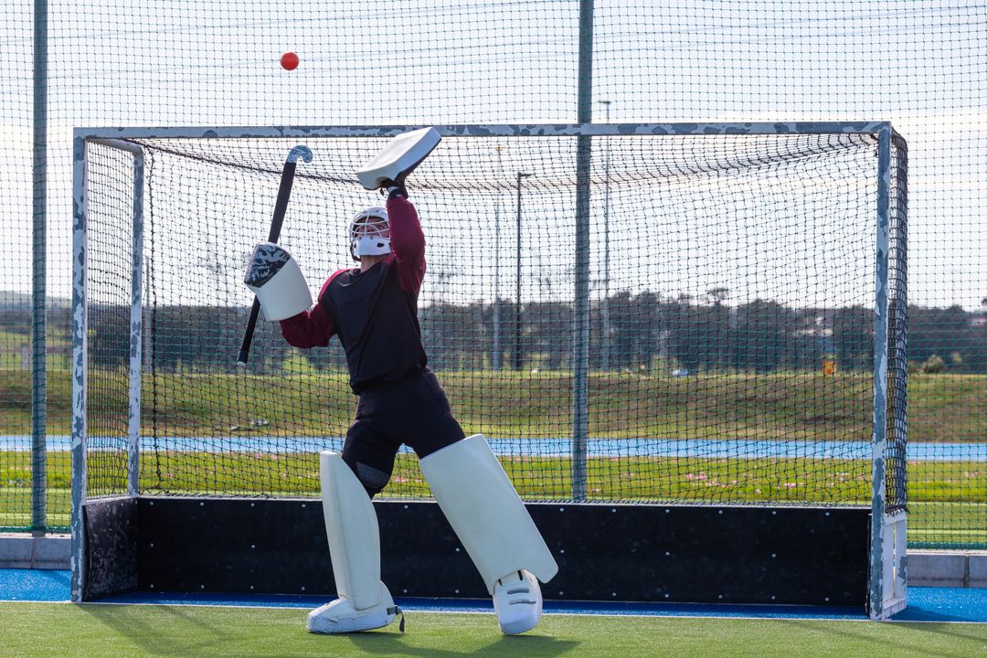 Field Hockey Goalkeeper in Action Blocking Ball
