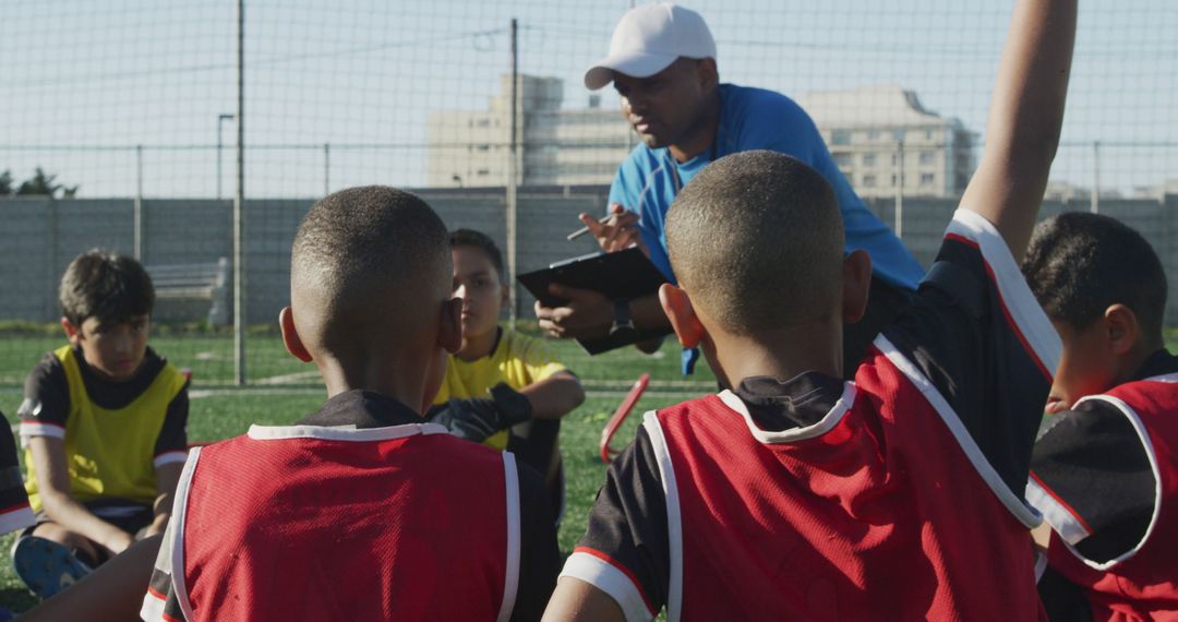 Soccer Coach Giving Instructions to Young Players during Training - Free Images, Stock Photos and Pictures on Pikwizard.com