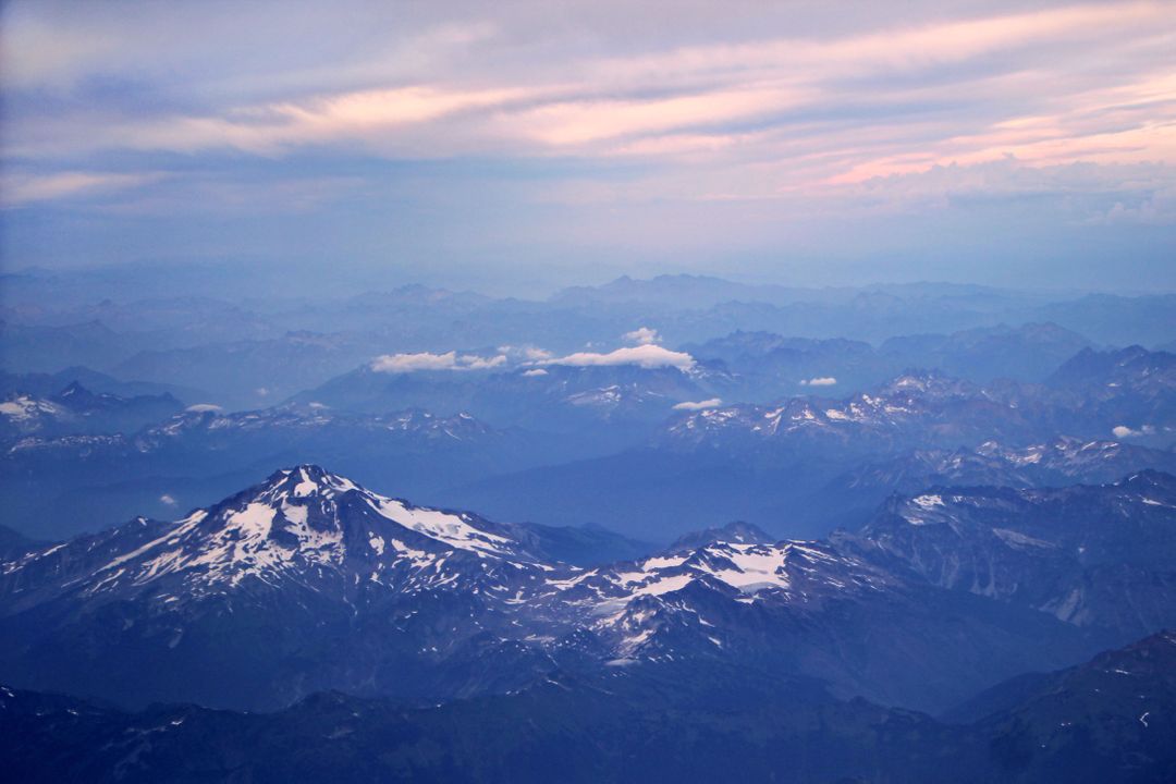 Aerial View of Mountain Range with Snow Capped Peaks at Sunset - Free Images, Stock Photos and Pictures on Pikwizard.com