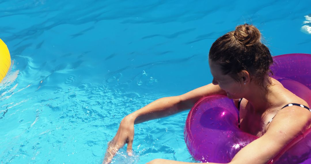 Woman Relaxing on Swim Ring in Bright Blue Pool - Free Images, Stock Photos and Pictures on Pikwizard.com