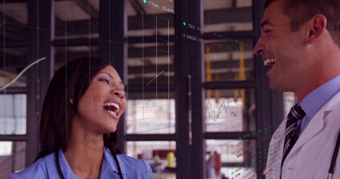Laughing Nurse and Physician Collaborating with Digital Charts on Wall, Healthcare Teamwork