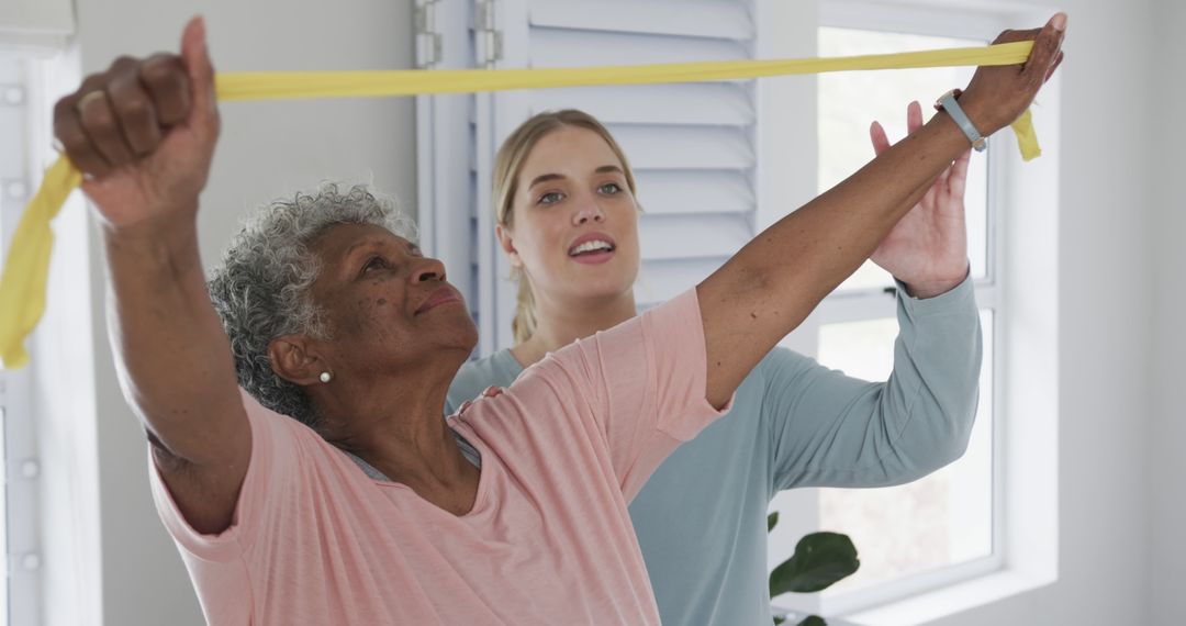 Senior Woman Exercising with Physical Therapist Using Resistance Bands - Free Images, Stock Photos and Pictures on Pikwizard.com