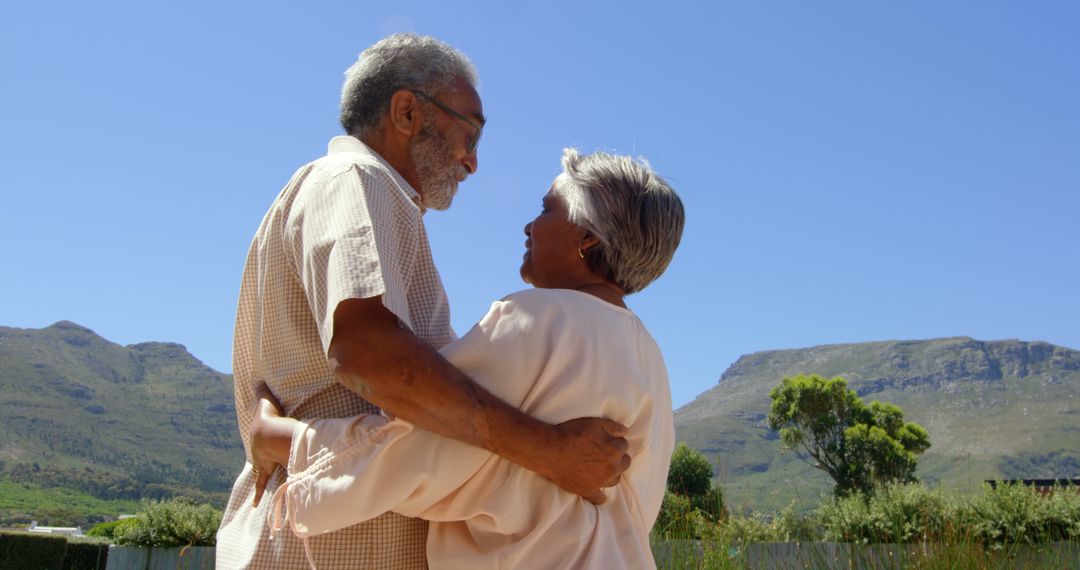 Happy Senior Couple Embracing Outdoors in Natural Landscapes - Free Images, Stock Photos and Pictures on Pikwizard.com