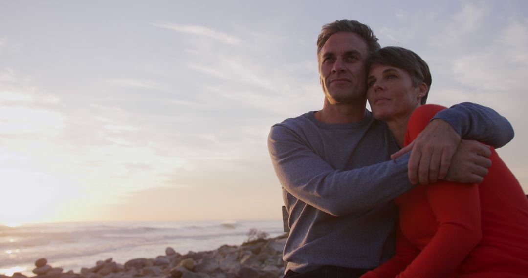 Mature Couple Embracing on Seaside at Sunset - Free Images, Stock Photos and Pictures on Pikwizard.com