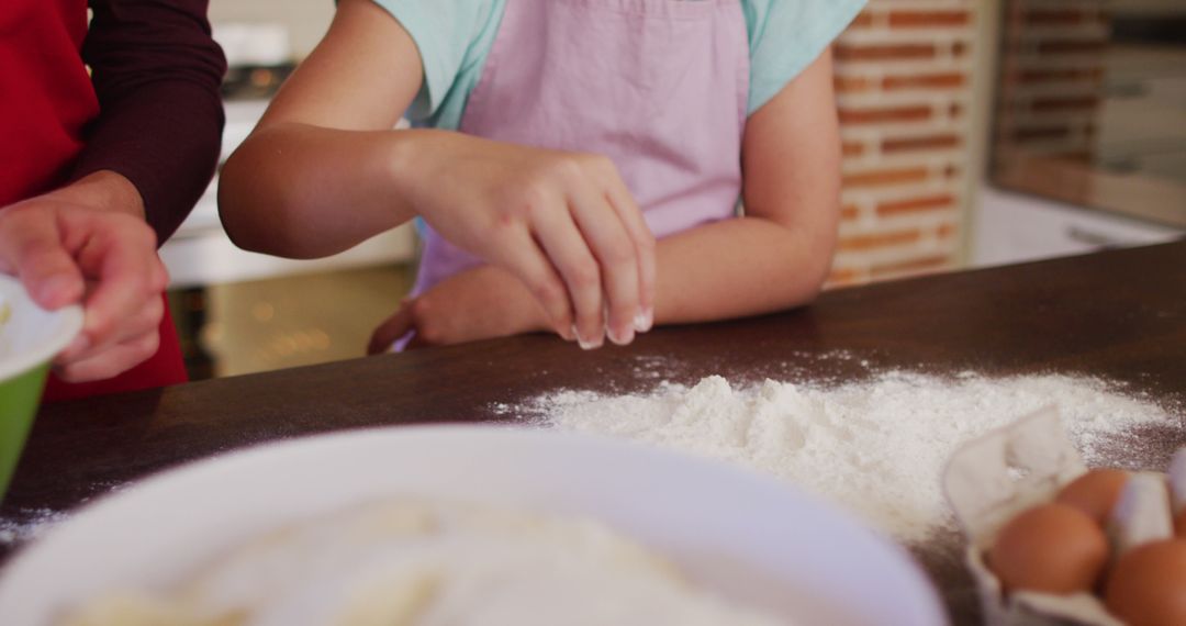 Child Preparing Dough with Parent in Kitchen - Free Images, Stock Photos and Pictures on Pikwizard.com