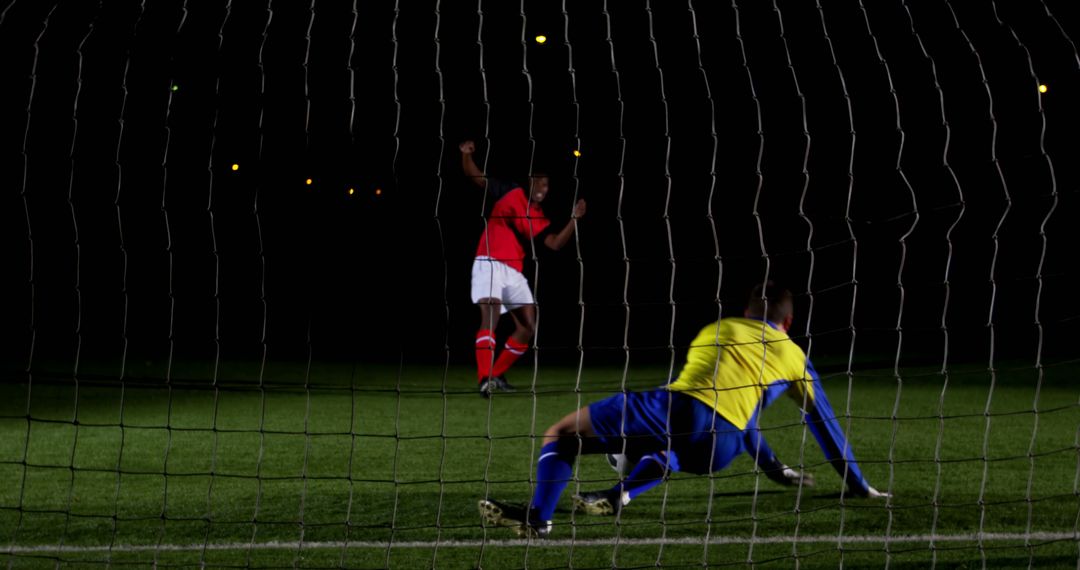 Soccer Goalkeeper Missing Save Shot Outdoors Nighttime Match - Free Images, Stock Photos and Pictures on Pikwizard.com