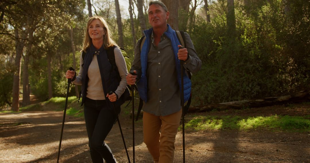 Mature Couple Enjoying Nordic Walking in Forest - Free Images, Stock Photos and Pictures on Pikwizard.com