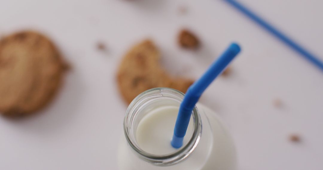 Milk Bottle with Straw and Cookies in Background - Free Images, Stock Photos and Pictures on Pikwizard.com