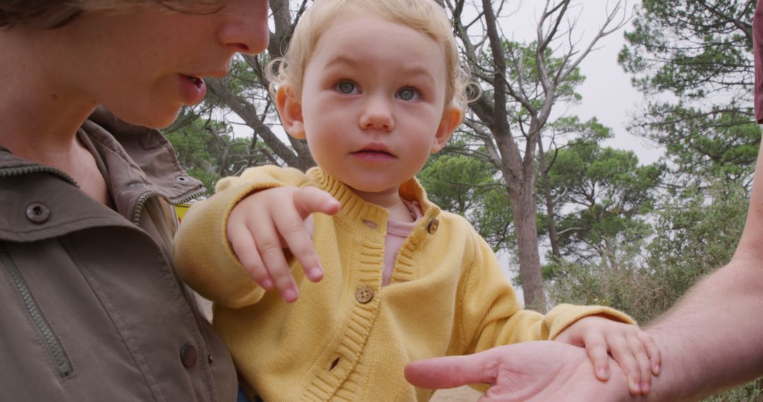 Toddler Pointing While Outside with Parents - Free Images, Stock Photos and Pictures on Pikwizard.com