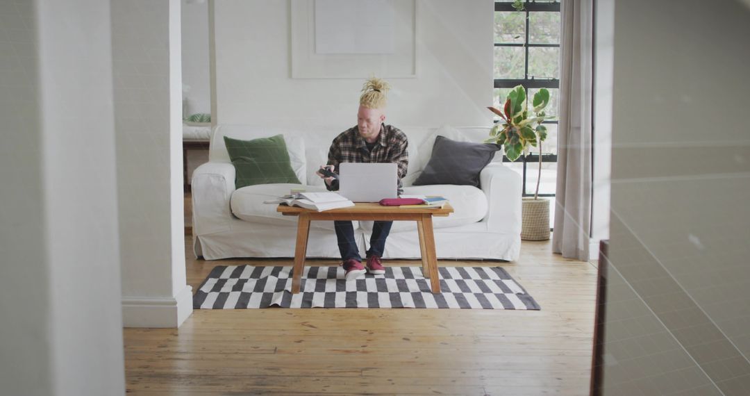 Man Typing on Laptop in Minimalist Home Office