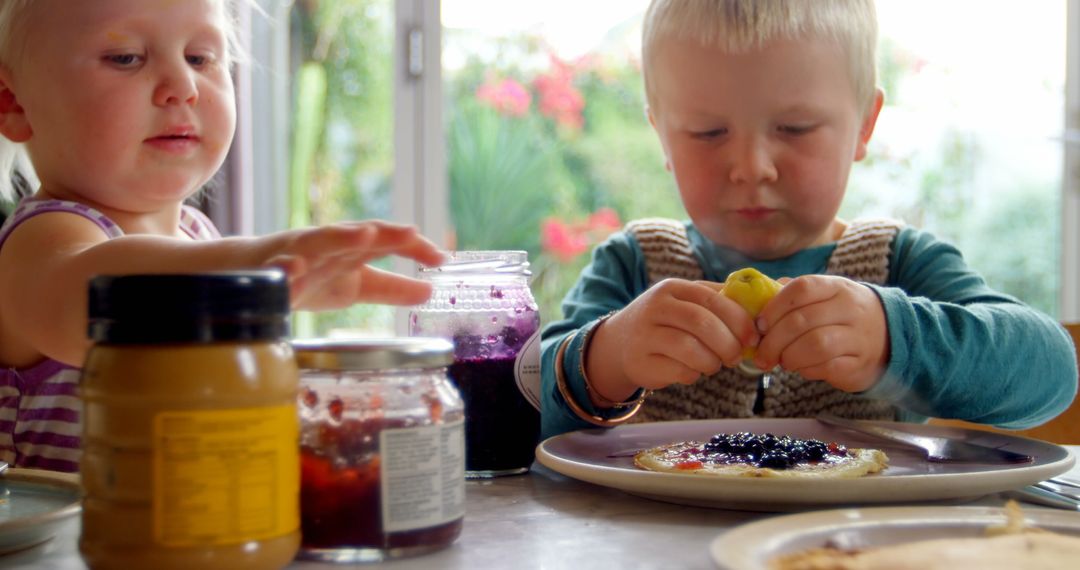 Young Caucasian Siblings Enjoying Pancakes Together at Home