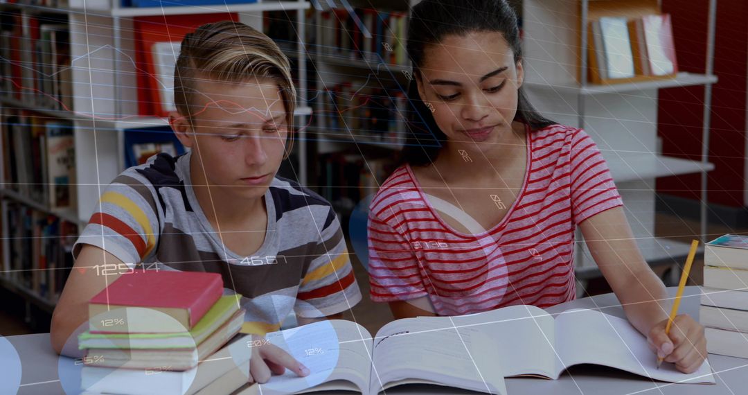Teen Students Studying Together in Library Reading Textbooks and Taking Notes for Homework