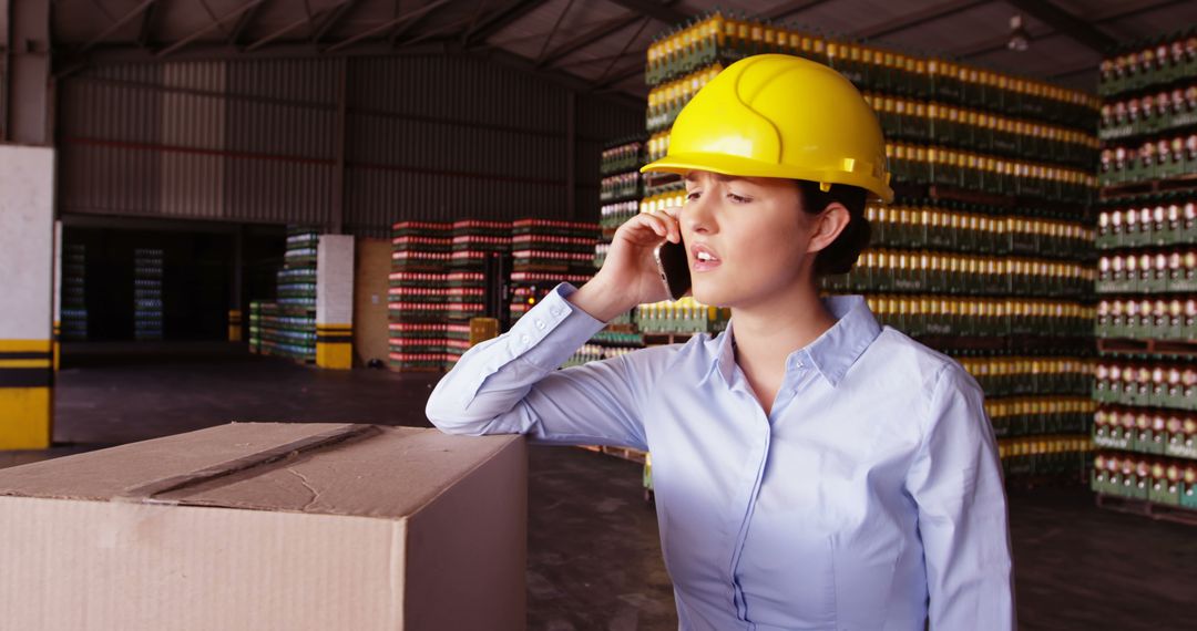 Female Warehouse Supervisor Talking on Phone - Free Images, Stock Photos and Pictures on Pikwizard.com