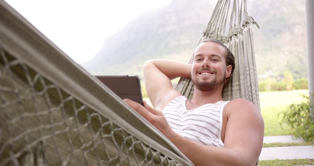 Relaxed Young Man in Hammock Enjoying Digital Leisure