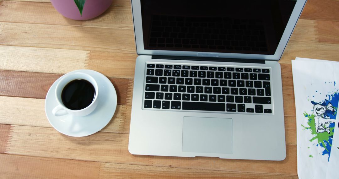 Open Laptop on Wooden Desk with Cup of Coffee Next to It in Casual Workspace - Free Images, Stock Photos and Pictures on Pikwizard.com