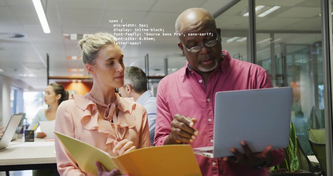 Diverse Colleagues Collaborating with Digital Interface in Creative Office