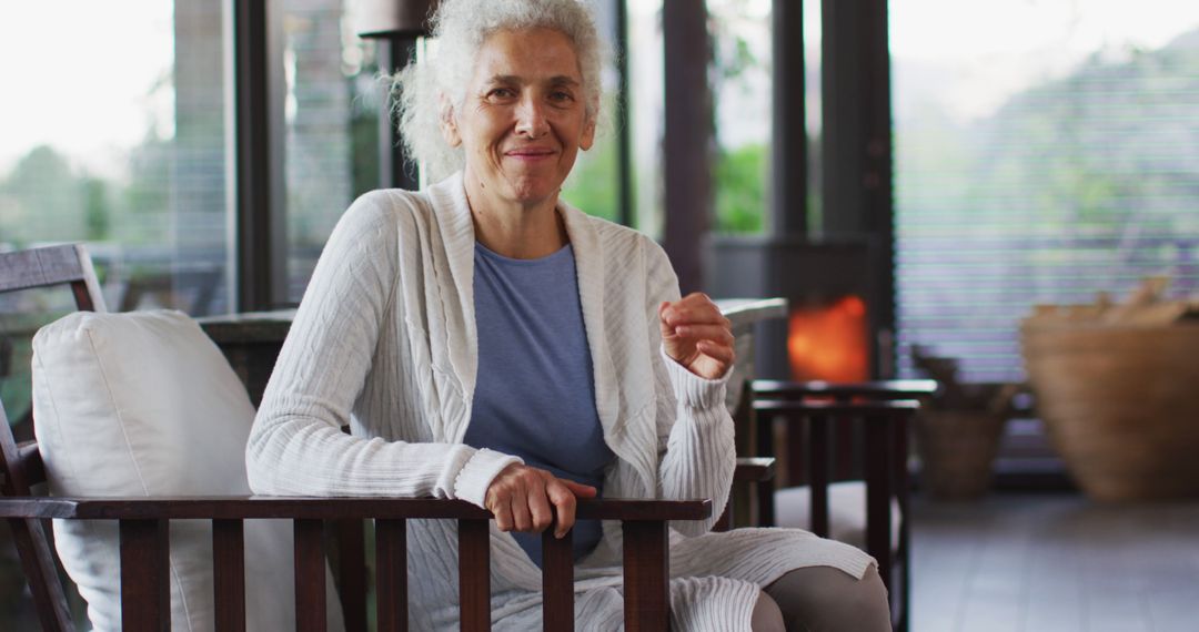 Smiling Elderly Woman Relaxing in Modern Living Room - Free Images, Stock Photos and Pictures on Pikwizard.com