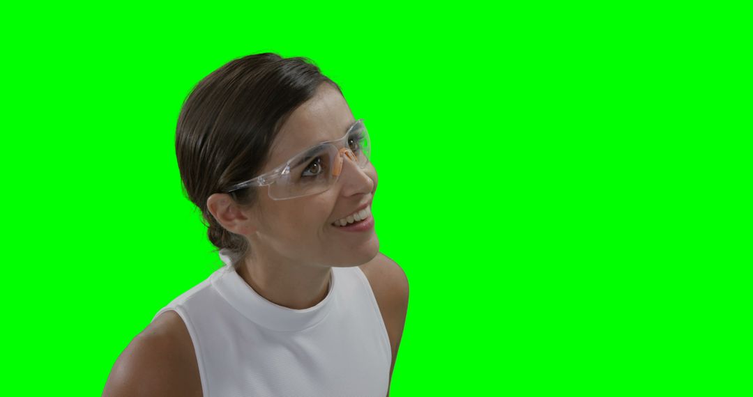 Businesswoman wearing futuristic eyewear while using digital screen against green screen - Free Images, Stock Photos and Pictures on Pikwizard.com