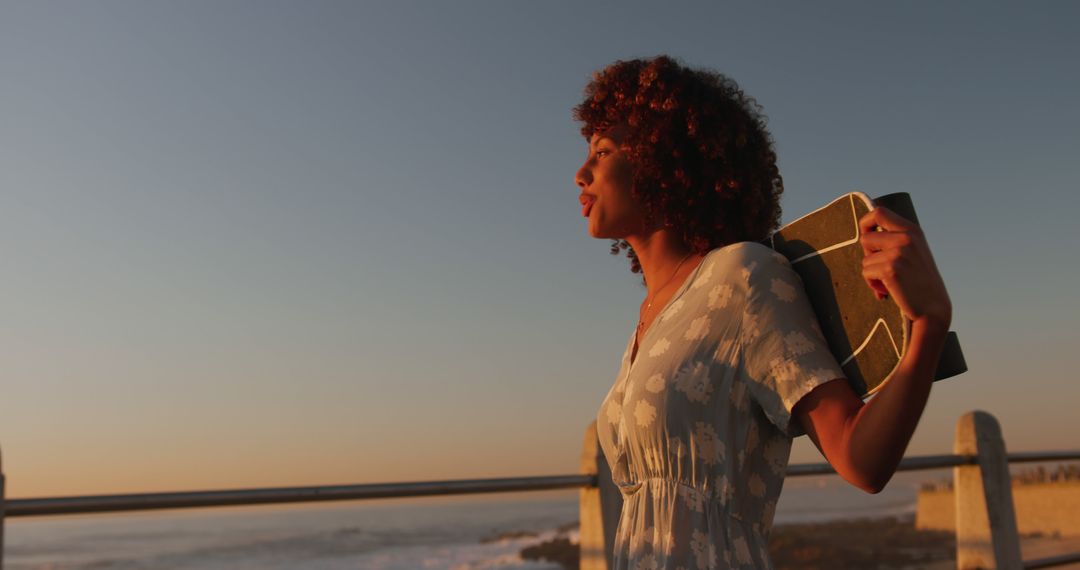 Woman Reflecting While Carrying a Surfboard at Sunset by the Ocean - Free Images, Stock Photos and Pictures on Pikwizard.com